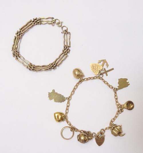 A 9ct gold oval link charm bracelet, with a 9ct gold heart shaped padlock and a boltring clasp, fitted with nine mostly 9ct gold charms, but including