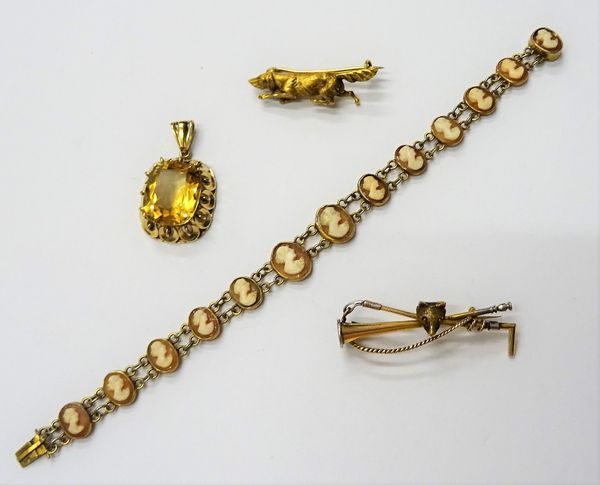 A gold brooch, designed as a foxes mask, a riding crop and a hunting horn, a gold brooch, designed as a dog, a shell cameo link bracelet, carved as th