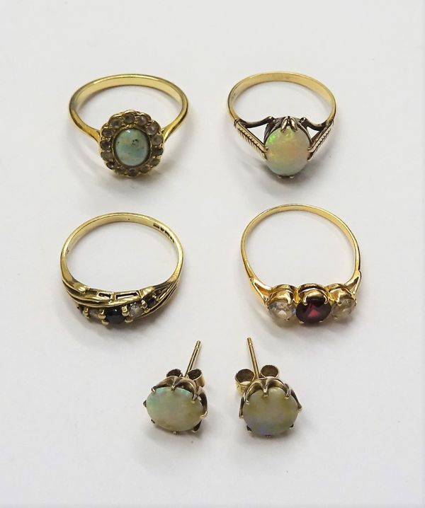 A gold ring, claw set with an oval opal, detailed 9 CT, a pair of opal single stone earstuds, a 9ct gold, sapphire and colourless gem set five stone r