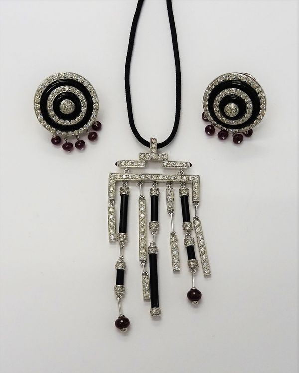 A Chinese style onyx, ruby and diamond set pendant necklace, comprising; a pendant set with brilliant cut diamonds, ruby beads and onyx, suspended fro