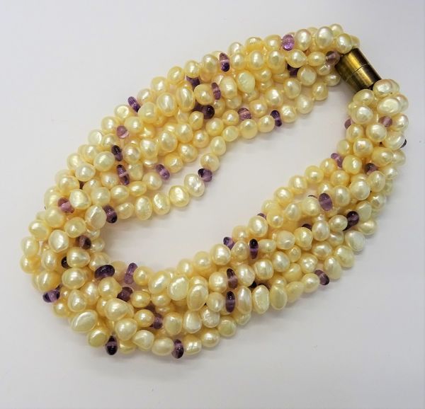 A ten strand baroque pearl and amethyst bead necklace of multi-twist design, retailed by Kiki McDonough, suspended from a silver gilt magnetic clasp,