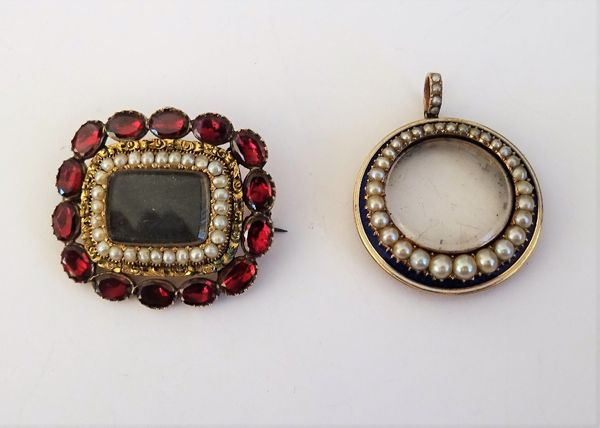 A gold, seed pearl and garnet set rectangular brooch, the centre glazed with a locket compartment within a surround of seed pearls and with a border o