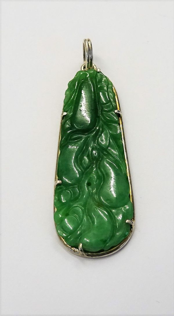 A silver mounted jade drop shaped pendant, with carved and pierced decoration, designed as fruit.