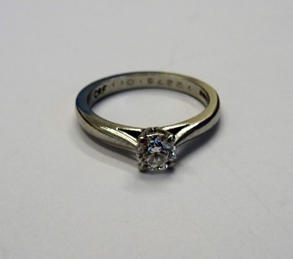 A platinum and diamond single stone ring, claw set with a circular cut diamond, ring size M, gross weight 4.8 gms.