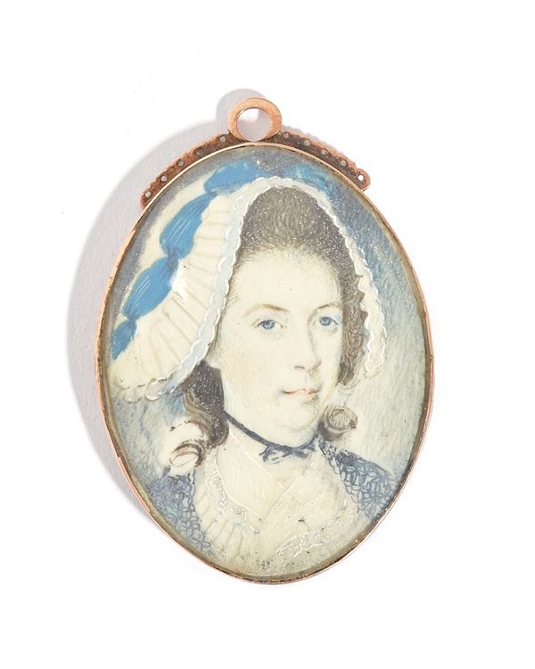 An oval portrait miniature of a lady wearing a bonnet, in an oval pendant mount as converted from a clasp, the back with engraved decoration, mid-19th