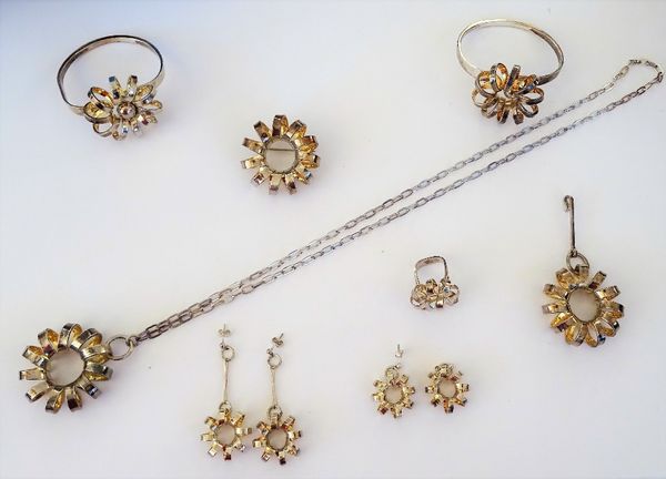 A group of eight items of Norwegian Sterling silver jewellery, each in a spiral design, comprising; two bangles, a brooch, a pendant with a neckchain,