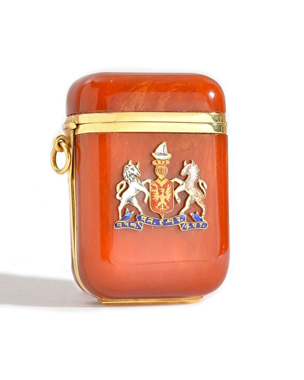 A gold mounted, curved rectangular amber vesta box, the interior with an oval locket compartment, the frame detailed 18 C, the exterior with an applie