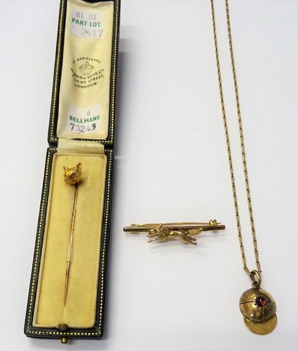 A 9ct gold bar brooch, with a running fox motif, weight 5 gms, a stick pin, the finial formed as a foxes mask, cased, a gold pendant, designed as a jo