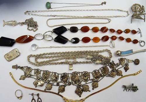 A group of silver and other jewellery, comprising; a necklace having pendant drops, probably Indian, two pendants with neckchains, a ropetwist link ne