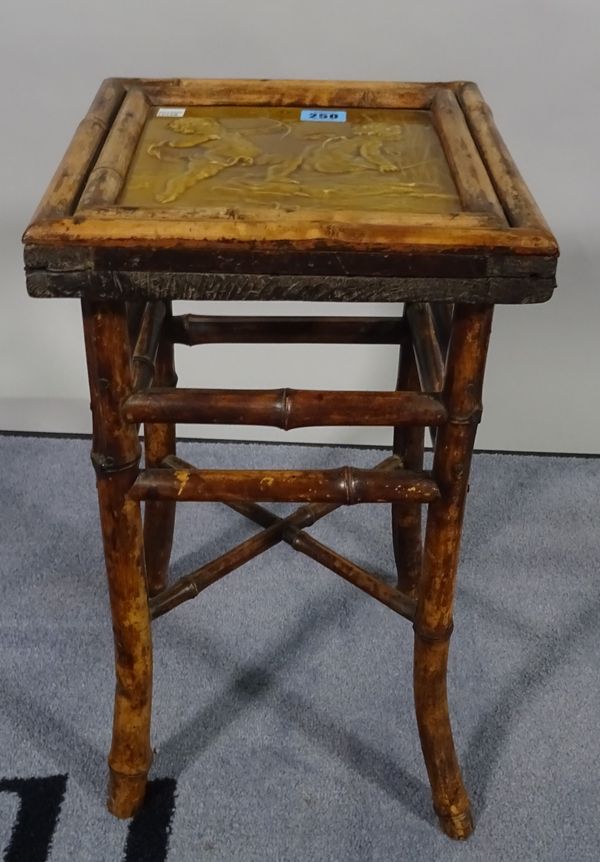 An early 20th century bamboo low side table with inset tile top, 28cm wide x 44cm high. D1