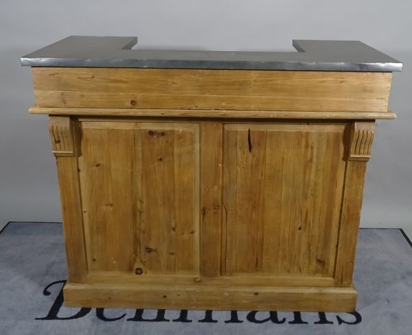 A 20th century pine bar with arrangement of shelves and wine racks, 120cm wide x 100cm high and a pair of 20th century black painted metal bar stools,