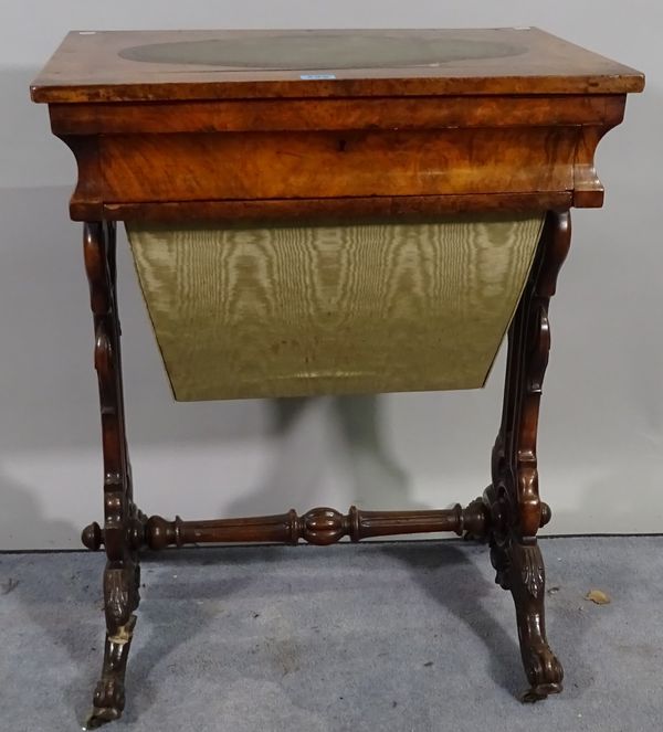 A late Victorian walnut work table with oval inset leather top on turned supports, 56cm wide x 71cm high. A1