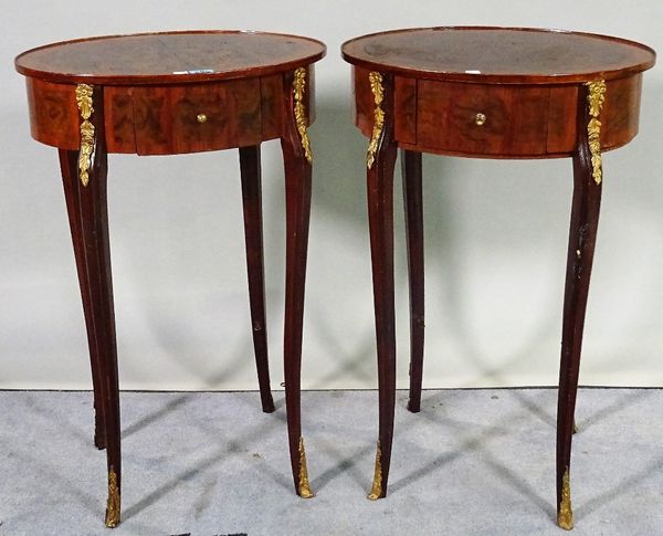 A pair of late 19th century French walnut with oval single drawer and gilt metal mounted side tables, 45cm wide x 69cm high, (2).   C1