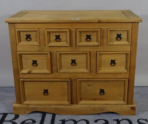 A 20th century pine chest of nine short graduated drawers on plinth base, 102cm wide x 83cm high.  B4