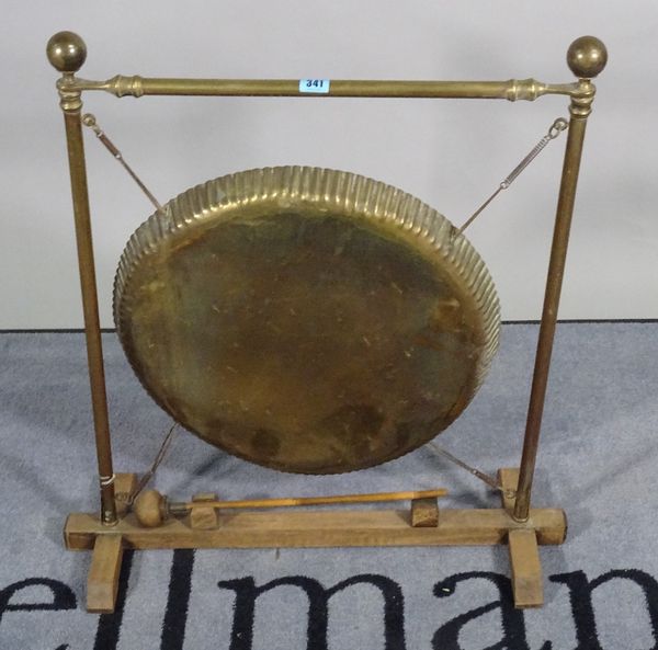 An early 20th century brass and oak framed dinner gong, 58cm wide x 74cm high. D1