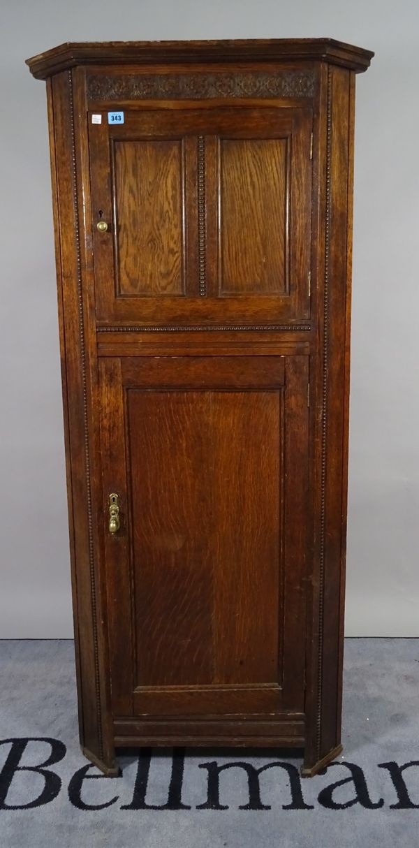 An 18th century style oak floor standing corner cabinet with panelled doors, 74cm wide x 166cm high.  B5