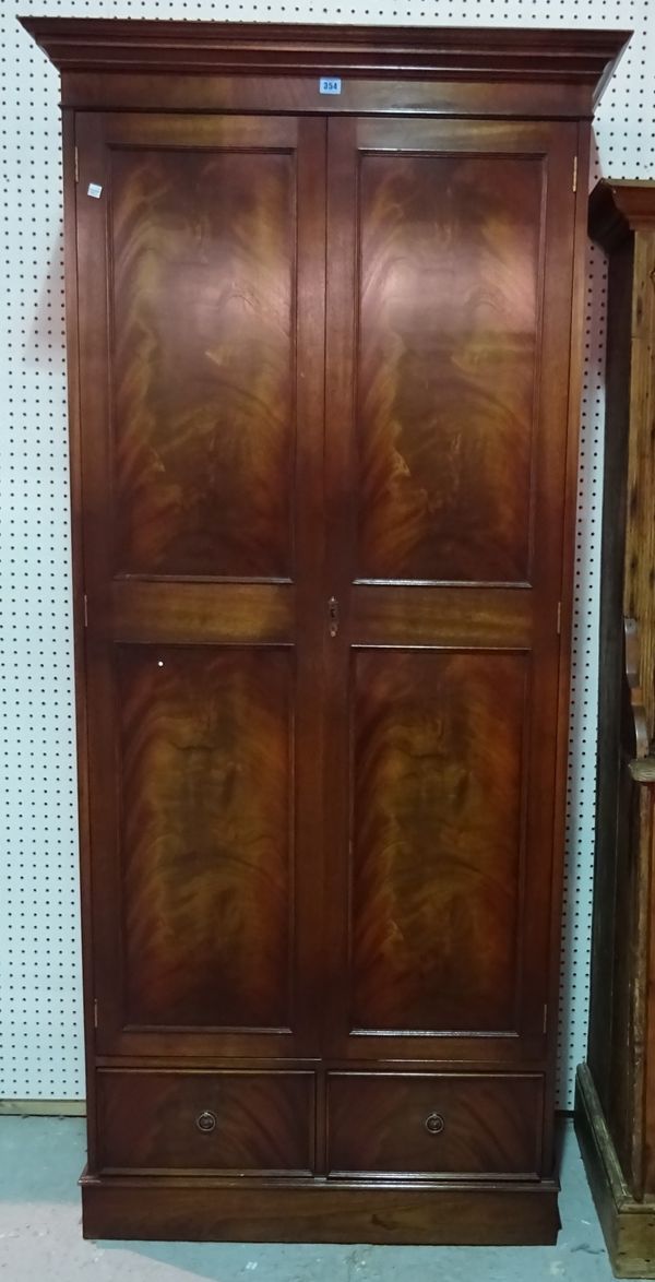 A 20th century mahogany single wardrobe with two drawers on plinth base, 99cm wide x 199cm high x 39cm deep.  C5