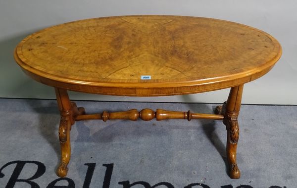 A Victorian walnut oval low table on outswept supports, 103cm wide x 55cm high, and a pair of Edwardian inlaid mahogany side chairs, 44cm wide x 84cm