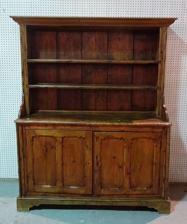 A late 19th century Continental pine kitchen dresser with two tier plate rack over cupboard door base, 142cm wide x 180cm high.  B5