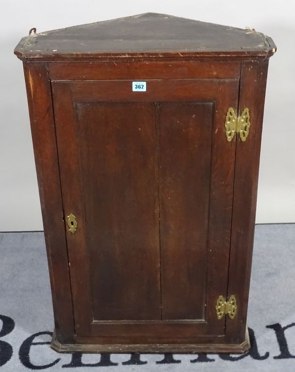 An 18th century and later oak hanging corner cupboard, 59cm wide x 91cm high.  B3