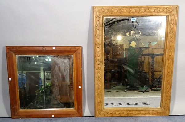 A 20th century pine framed rectangular wall mirror with carved decoration, 64cm wide x 88cm high and another smaller pine framed mirror, 62cm wide x 5