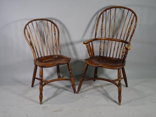 A set of six 19th century ash and elm stick back dining chairs, 57cm wide x 100cm high, to include two carvers and another similar open armchair, (7).