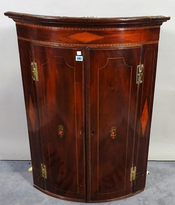 A late George III mahogany inlaid bowfront hanging corner cupboard, 76cm wide x 102cm high.  B3