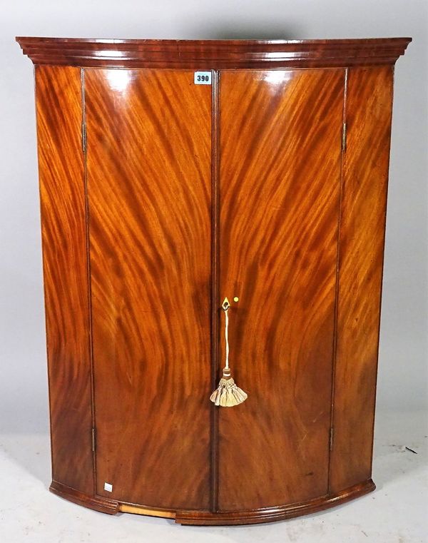 An 18th century mahogany bowfront hanging corner cabinet, 77cm wide x 100cm high. A1