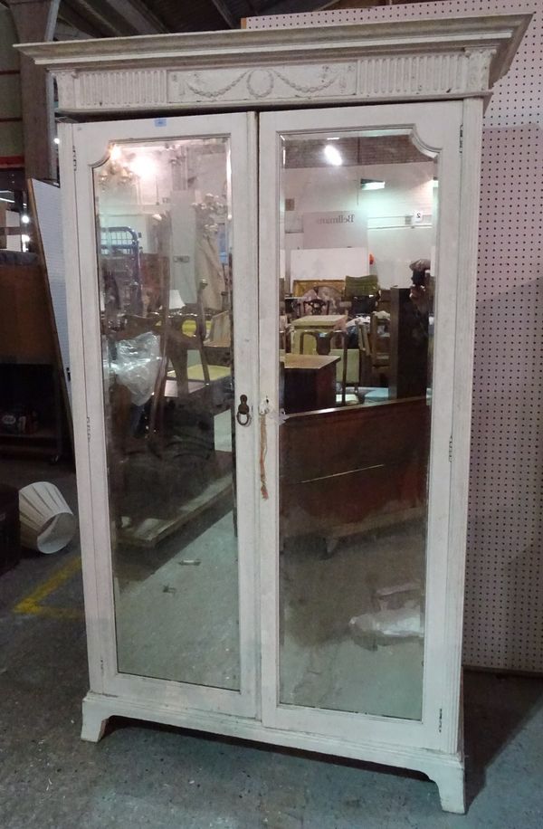 A late Victorian white painted single wardrobe with central mirrored door, 135cm wide x 201cm high.  A2