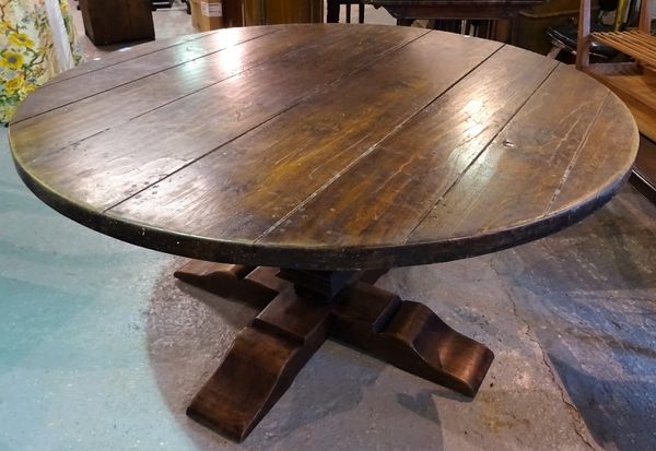 A 20th century oak circular dining table on turned column and 'X' frame base, 150cm wide x 78cm high.  D4