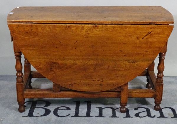 An 18th century and later oak and elm drop flap gate leg table, 117cm wide x 69cm high. A1