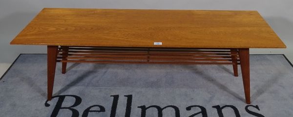 A 20th century teak rectangular coffee table on tapering supports, 138cm wide x 45cm high. D4