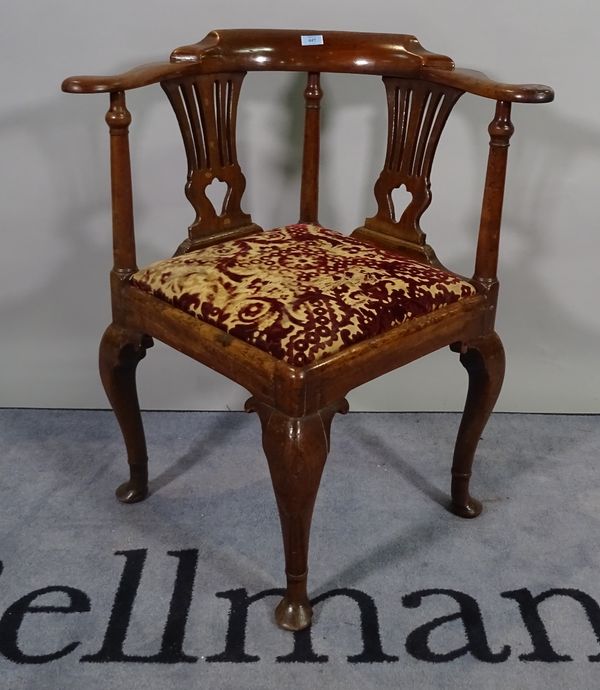 A George III mahogany corner armchair on tapering pad feet, 73cm wide x 80cm high. D2