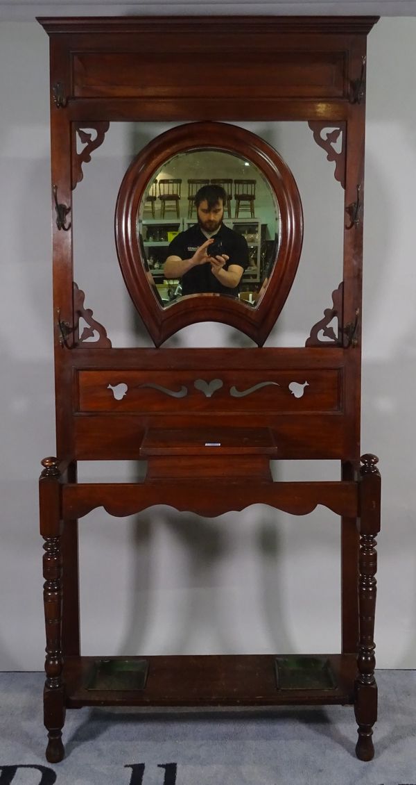 A late Victorian mahogany hall stand with oval mirror plate, 72cm wide.  C5