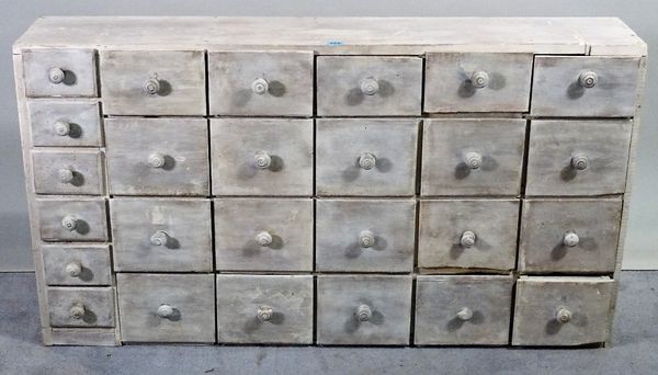 A 20th century blue painted bank of twenty six various drawers,116cm wide x 64cm high.  C1