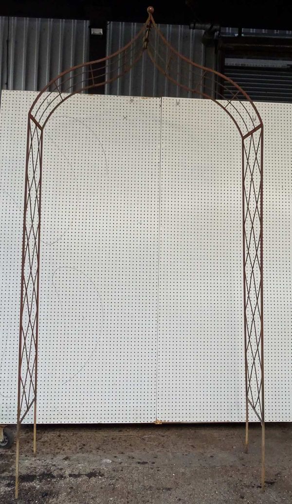 An early 20th century wrought iron arch top gazebo, 134cm wide x 272cm high.  OUT