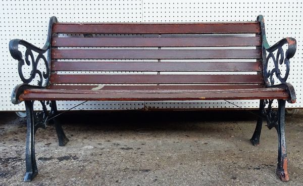 A 20th century black painted cast iron garden bench with scroll ends and wooden slats, 128cm wide x 78cm high.   OUT