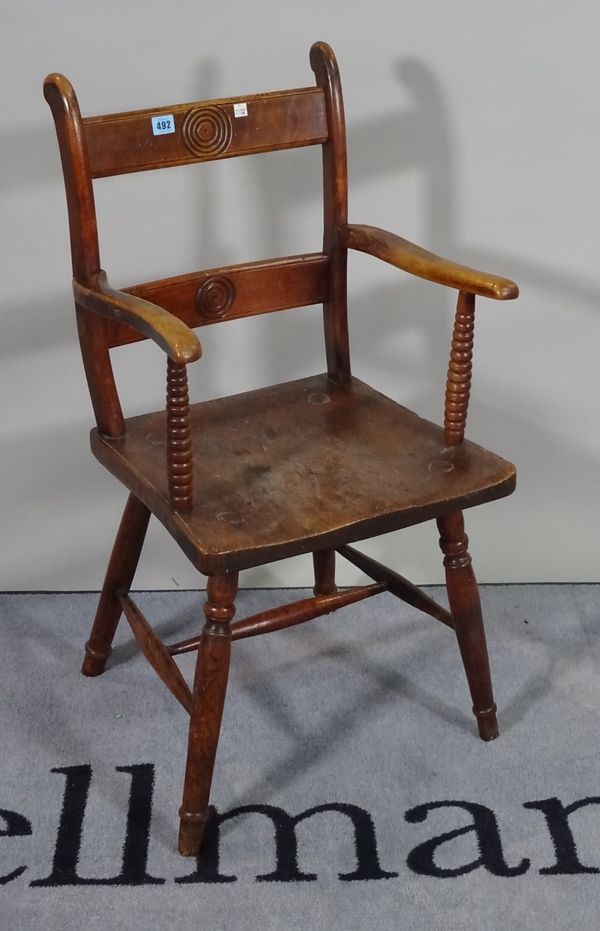 A 19th century beech and elm seated open armchair with bullseye back on turned supports, 45cm wide x 88cm high.  A1