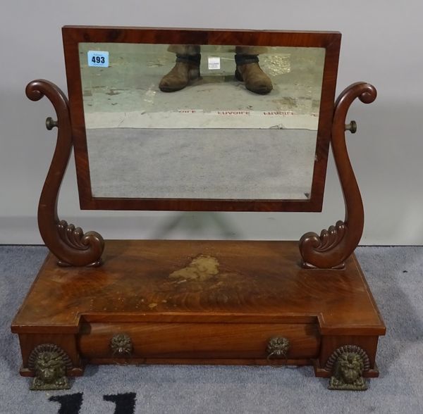 An Empire mahogany swing frame toilet mirror with cushion drawer base and gilt metal lions mask supports, 59cm wide x 52cm high.  C5