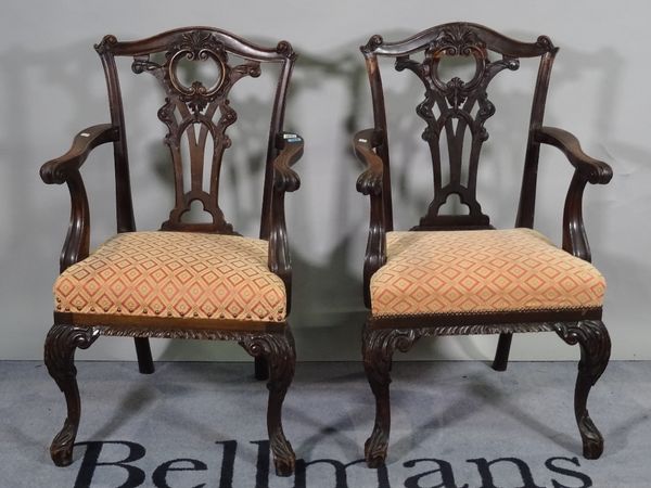 A pair of late 19th century mahogany open armchairs, of mid-18th century design, on scroll supports, 60cm wide x 99cm high, (2).  D8