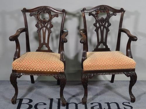 A pair of late 19th century mahogany open armchairs, of mid-18th century design, on scroll supports, 60cm wide x 99cm high, (2).  D8