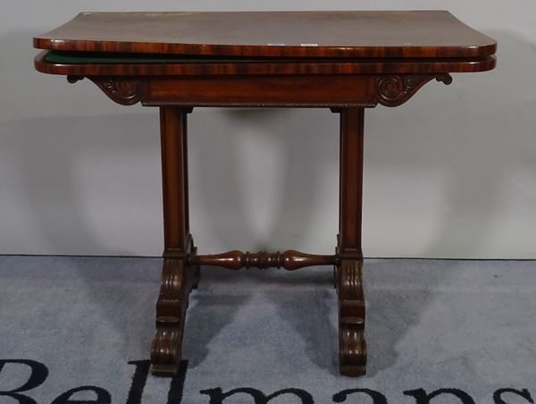 A Regency mahogany card table, the fold over 'D' shaped top on a pair of trestle supports, 92cm wide x 72cm high.  D3