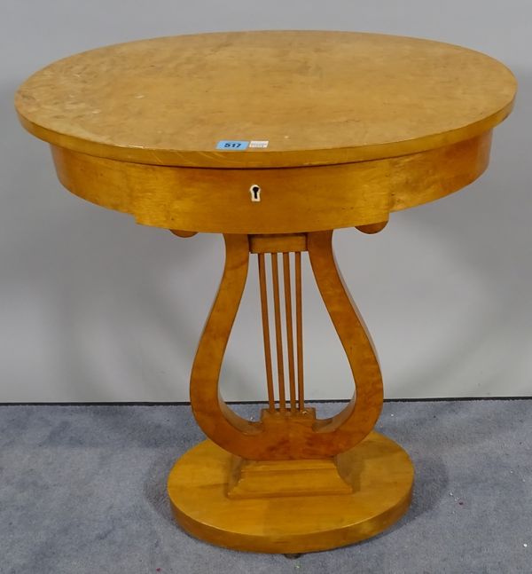 A Biedermeier style satin birch single drawer oval side table on large column plinth base, 60cm wide x 72cm high. C1