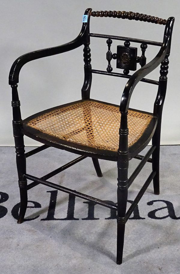 An early 19th century ebonised open armchair, with bobbin turned crest rail and splayed supports, 50cm wide x 82cm high.  D3