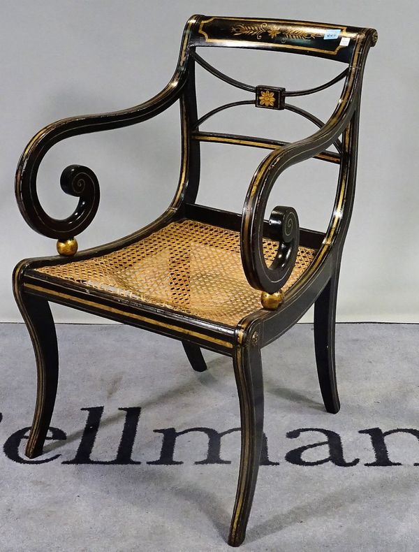 A Regency parcel gilt ebonised open armchair with 'X' frame back and sabre supports, 55cm wide x 84cm high.  B3