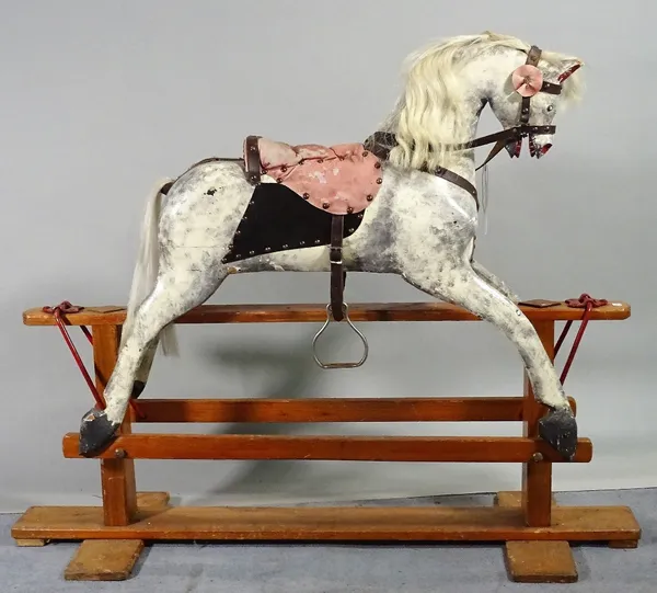 An early 20th century white and grey painted rocking horse on pine stand, 115cm wide x 96cm high. C1