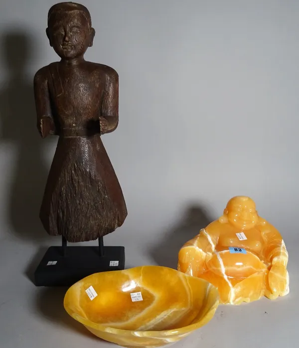 A 20th century polished hardstone figure of a Buddha, 14cm high, a matching bowl, 24cm wide and an Asian hardwood figure on stand, 52cm high, (3).  S4