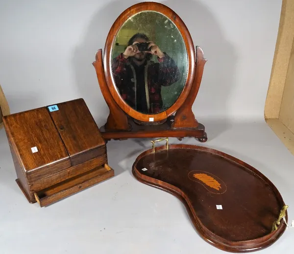 An Edwardian inlaid mahogany kidney shaped galleried tray, 58cm wide, an oak slope fronted stationary box, 30cm wide x 25cm high and a late Victorian