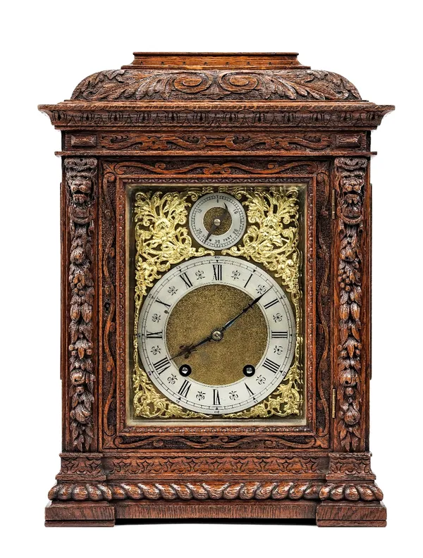 A German oak cased mantel clock, early/mid 20th century, with foliate carved case, gilt plate with subsidiary slow/fast dial and a two train Lenzkirch