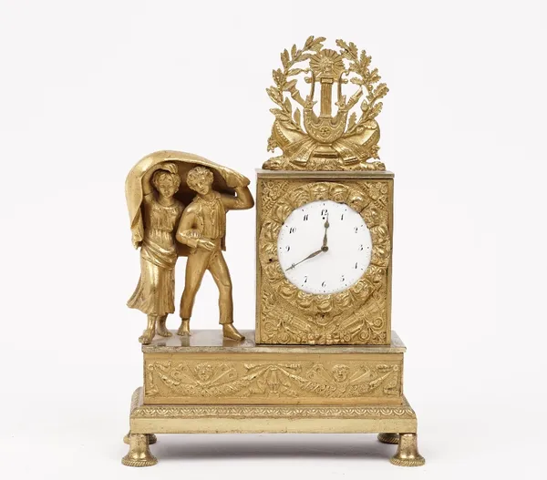 A 19th century gilt bronze figural mantel clock with two children hiding under a blanket and floral harp cast finial over an enamelled dial, rectangul